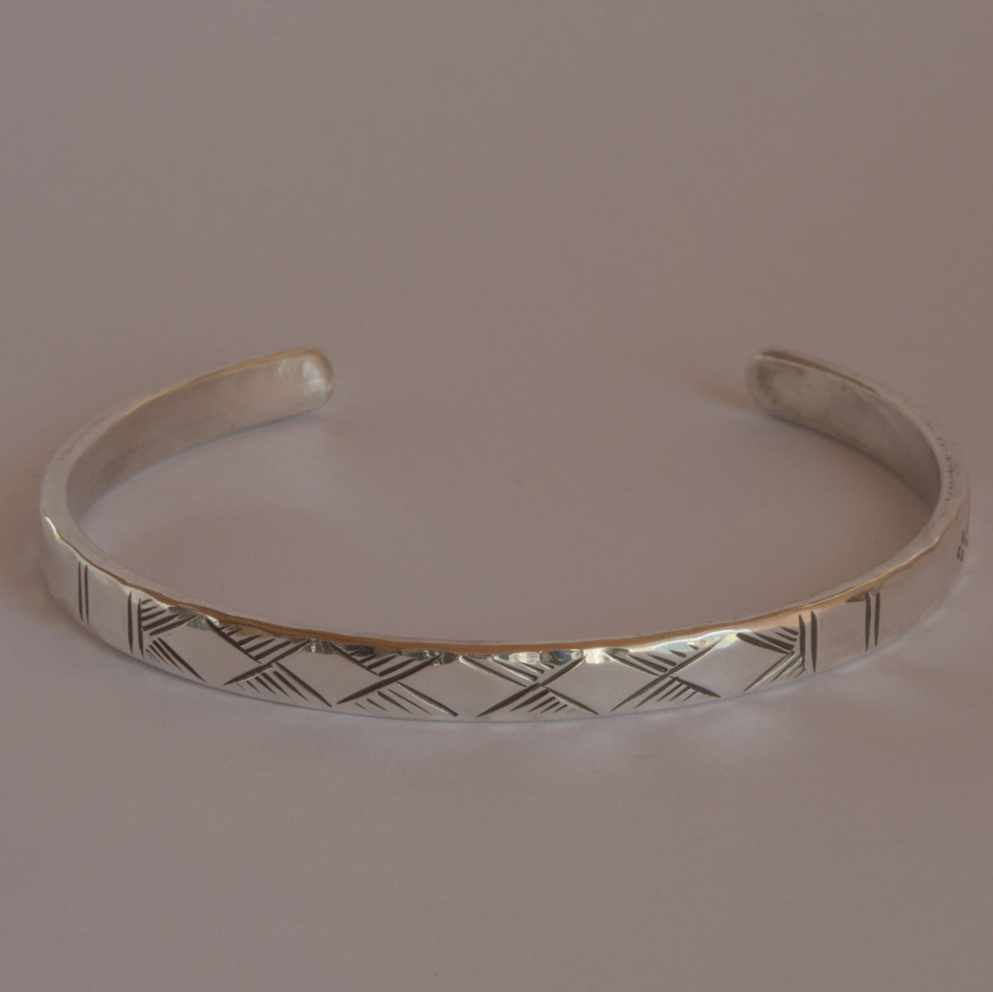 hammered silver bracelet with engraved motifs 