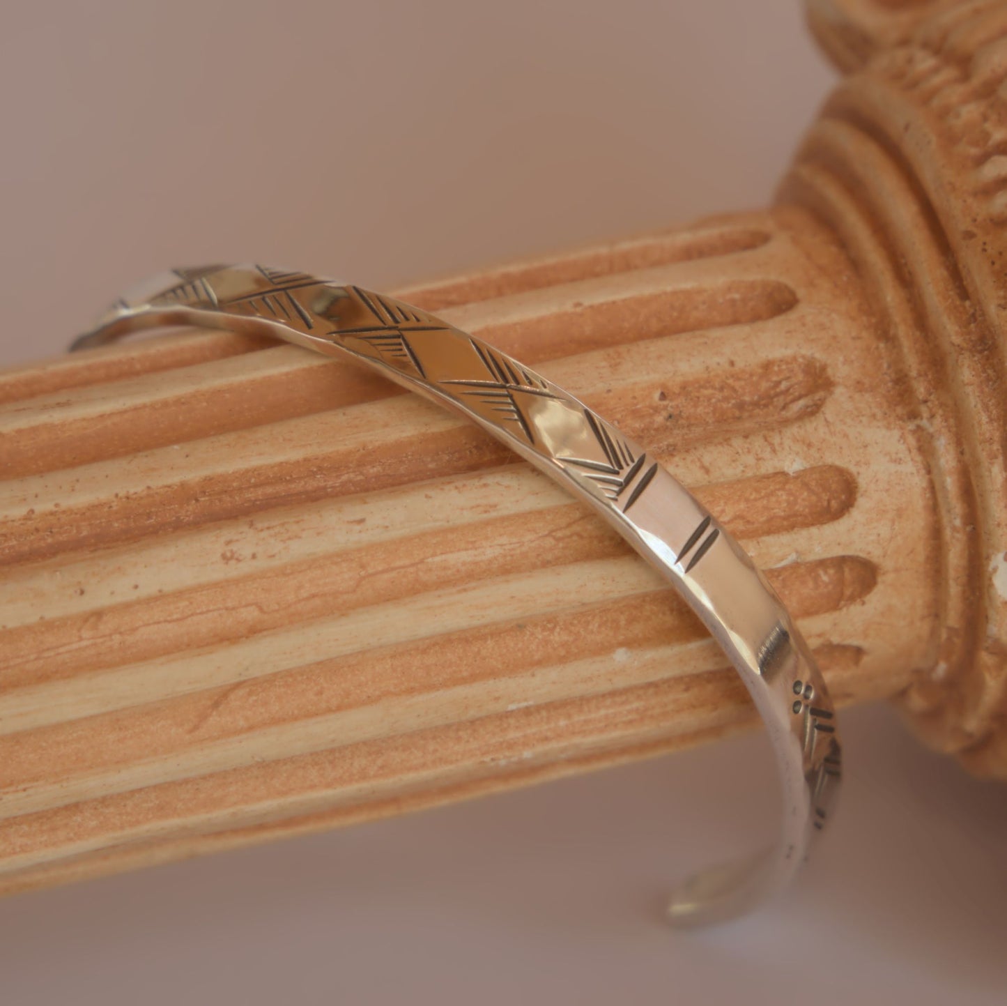 hammered silver bracelet with engraved motifs 