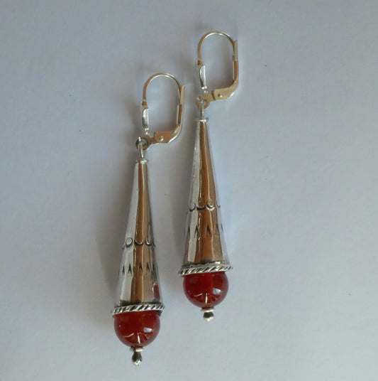 silver earrings in the shape of a cone with a fine stone